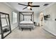 This bedroom features a four poster bed frame, carpet flooring and view into the ensuite bathroom at 2155 Cerulean Sky Dr, Lutz, FL 33558