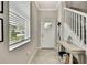 Bright foyer featuring tile flooring and a staircase to the upper level at 2155 Cerulean Sky Dr, Lutz, FL 33558