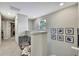 Bright hallway featuring neutral walls, framed pictures, and an abundance of natural light at 2155 Cerulean Sky Dr, Lutz, FL 33558