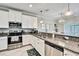 Kitchen featuring granite countertops, stainless steel appliances and white cabinets at 2155 Cerulean Sky Dr, Lutz, FL 33558