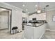 Bright kitchen features granite counters, stainless appliances, white cabinets and recessed lighting at 2155 Cerulean Sky Dr, Lutz, FL 33558