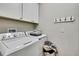 Convenient laundry room with updated washer and dryer plus extra storage cabinets at 2155 Cerulean Sky Dr, Lutz, FL 33558