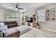 Spacious living room with decorative rug, stylish furniture and lots of natural light at 2155 Cerulean Sky Dr, Lutz, FL 33558