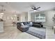 Open-concept living room with a large sectional sofa and tiled flooring at 2155 Cerulean Sky Dr, Lutz, FL 33558