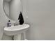 Powder room features a pedestal sink and modern decor at 2155 Cerulean Sky Dr, Lutz, FL 33558