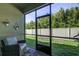 Relaxing screened porch with views of the backyard at 2155 Cerulean Sky Dr, Lutz, FL 33558
