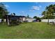 Spacious backyard with a covered structure, shed, white fence, and ample green space at 2334 14Th N Ave, St Petersburg, FL 33713