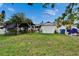 Backyard featuring a shed, covered structure, lawn area, and storage containers at 2334 14Th N Ave, St Petersburg, FL 33713