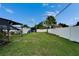 Backyard featuring a white fence, lawn area, shed, and a covered structure at 2334 14Th N Ave, St Petersburg, FL 33713