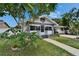 Inviting one-story home with a well-maintained lawn, mature tree, and a convenient covered carport for parking at 2334 14Th N Ave, St Petersburg, FL 33713
