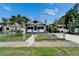 Charming single-story home featuring a well-manicured lawn and a secure, gated front yard, with beautiful trees and landscaping at 2334 14Th N Ave, St Petersburg, FL 33713