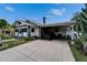 One-story home with a convenient carport, showcasing ample parking space and a beautifully maintained exterior at 2334 14Th N Ave, St Petersburg, FL 33713