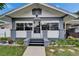 Charming bungalow featuring a symmetrical facade, gray trim, and a well-maintained landscaped yard at 2334 14Th N Ave, St Petersburg, FL 33713