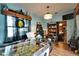 A unique game room with a pinball machine and view into an adjacent dining area at 2334 14Th N Ave, St Petersburg, FL 33713