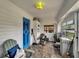 Bright and airy sunroom with tile flooring, multiple windows, and a striking blue entry door at 2334 14Th N Ave, St Petersburg, FL 33713