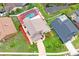 A high aerial shot showing a home, screened pool, and a brick driveway in a beautiful neighborhood at 277 Wood Dove Avenue, Tarpon Springs, FL 34689
