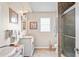 Traditional bathroom featuring dual sinks with pink granite countertops and tile shower at 277 Wood Dove Avenue, Tarpon Springs, FL 34689