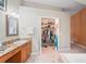 Bathroom with a single vanity, a large closet, and tile flooring at 277 Wood Dove Avenue, Tarpon Springs, FL 34689