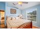Bedroom with a window overlooking the yard, and light blue walls at 277 Wood Dove Avenue, Tarpon Springs, FL 34689