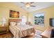 A comfortable bedroom with a ceiling fan and outdoor view at 277 Wood Dove Avenue, Tarpon Springs, FL 34689