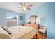 Bedroom with window, light blue walls, and a ceiling fan at 277 Wood Dove Avenue, Tarpon Springs, FL 34689