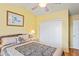 Bedroom with ceiling fan, a large closet, and light wood floors at 277 Wood Dove Avenue, Tarpon Springs, FL 34689