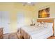 Well-lit bedroom with ceiling fan and light yellow walls at 277 Wood Dove Avenue, Tarpon Springs, FL 34689