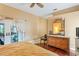 Bedroom with hardwood floors, decorative mirror, and access to an outdoor area at 277 Wood Dove Avenue, Tarpon Springs, FL 34689
