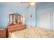 Bedroom with light blue walls, a ceiling fan, and a large dresser with a mirror at 277 Wood Dove Avenue, Tarpon Springs, FL 34689