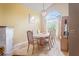 Bright dining room with fireplace, large window, tile floors, and a chandelier at 277 Wood Dove Avenue, Tarpon Springs, FL 34689