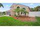 Attractive house with a manicured lawn, lush landscaping, and a charming garden area, enhancing its curb appeal at 277 Wood Dove Avenue, Tarpon Springs, FL 34689