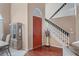 Bright foyer with hardwood floors, a staircase, and a view of the dining room at 277 Wood Dove Avenue, Tarpon Springs, FL 34689