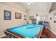 Well-lit game room with a blue felt pool table and lots of decor on the walls at 277 Wood Dove Avenue, Tarpon Springs, FL 34689