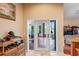 Hallway featuring access to a lanai, tile floors, and wicker furniture at 277 Wood Dove Avenue, Tarpon Springs, FL 34689