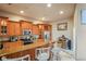 Well lit kitchen with wooden cabinets, granite counters, stainless steel appliances, and a cozy breakfast bar with seating at 277 Wood Dove Avenue, Tarpon Springs, FL 34689
