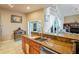 Bright kitchen featuring granite countertops, wooden cabinetry, and stainless steel appliances at 277 Wood Dove Avenue, Tarpon Springs, FL 34689