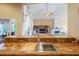 Bright kitchen featuring granite countertops, wooden cabinetry, and a stainless steel sink at 277 Wood Dove Avenue, Tarpon Springs, FL 34689