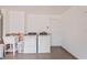 Functional laundry room with a utility sink, washer, and dryer, designed for convenience and efficiency at 277 Wood Dove Avenue, Tarpon Springs, FL 34689