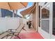 View of patio with awning, chair, grill, and motorcycle at 277 Wood Dove Avenue, Tarpon Springs, FL 34689