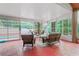 Enclosed patio area includes wicker furniture and overlooks the pool at 277 Wood Dove Avenue, Tarpon Springs, FL 34689