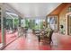 Enclosed patio area has multiple seating areas and overlooks backyard at 277 Wood Dove Avenue, Tarpon Springs, FL 34689
