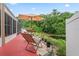 View of patio with chairs and umbrella in backyard overlooking pond and nature at 277 Wood Dove Avenue, Tarpon Springs, FL 34689