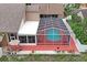 Aerial view of a screened-in pool and patio area, perfect for outdoor relaxation and entertainment at 277 Wood Dove Avenue, Tarpon Springs, FL 34689