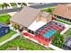 Aerial view of a home with a screened-in pool area and an adjacent patio with chairs and umbrella at 277 Wood Dove Avenue, Tarpon Springs, FL 34689