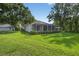 Expansive backyard with well-maintained lawn and screened-in porch, perfect for outdoor living at 2772 Golf Lake Dr # 03, Plant City, FL 33566
