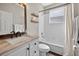 Neutral bathroom with shower-tub combo, white tiles, floating shelves, and marble sink at 2772 Golf Lake Dr # 03, Plant City, FL 33566
