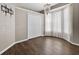 Bedroom with hardwood floors, white closet doors and a curtained bay window with a chandelier at 2772 Golf Lake Dr # 03, Plant City, FL 33566