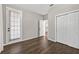 A bedroom featuring white walls, hardwood floors, closet space, and a door leading to the outdoors at 2772 Golf Lake Dr # 03, Plant City, FL 33566