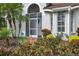 Close up of the front door of a property with screened entry and lush landscaping at 2772 Golf Lake Dr # 03, Plant City, FL 33566