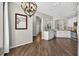 Open-concept view of the hallways, kitchen, and dining areas with dark wood floors and modern lighting at 2772 Golf Lake Dr # 03, Plant City, FL 33566